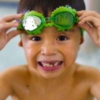 Smiling boy with green goggles