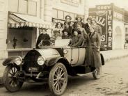 A carload of girls in front of the Cosy Theater in the early 1900's