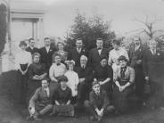 A black and white group photograph of the Settlemier Family, with family members seated or standing around Jesse Settlemier