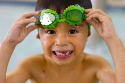 Smiling boy with green goggles